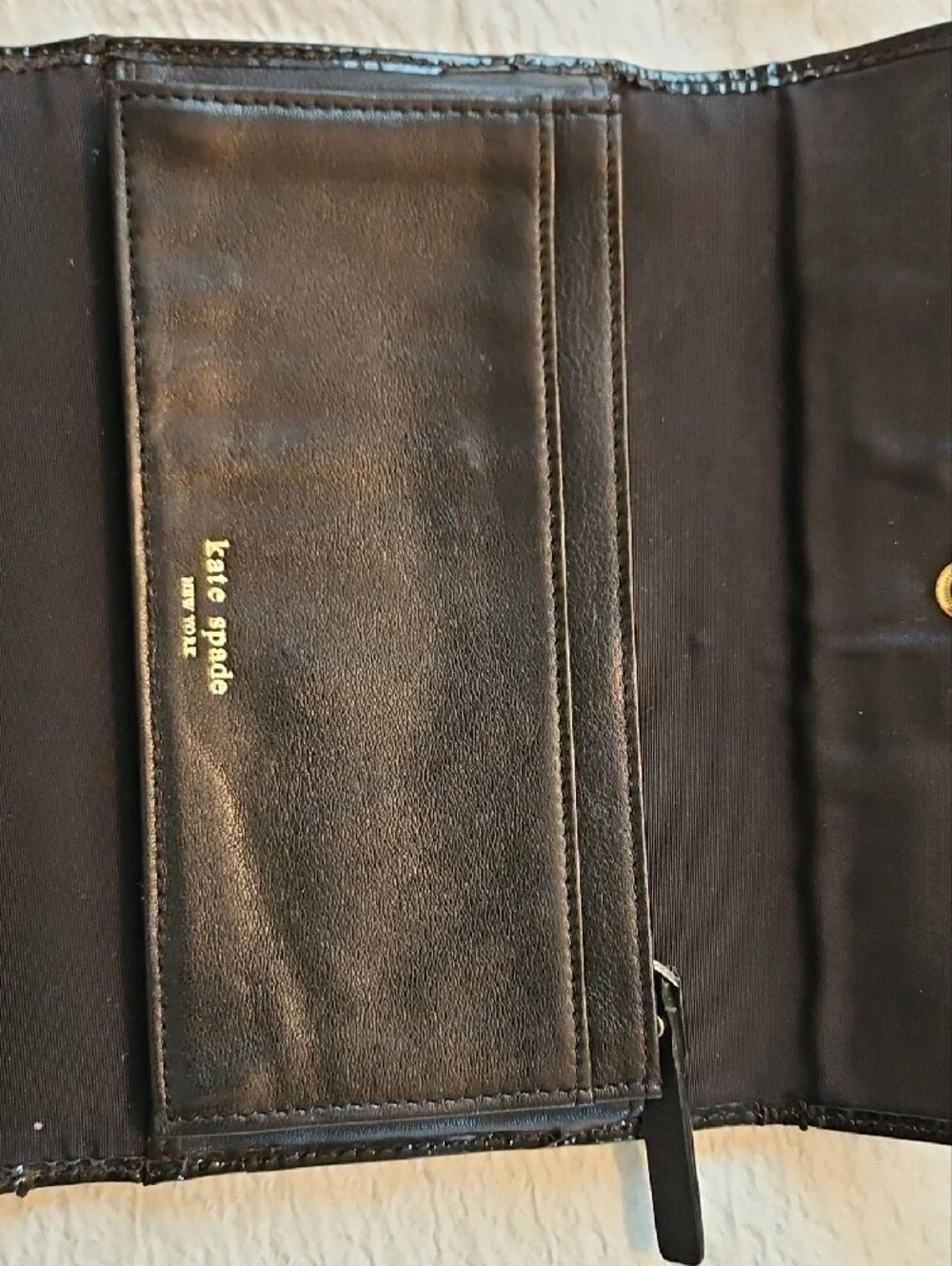 kate spade black wallet with gold-tone nameplate